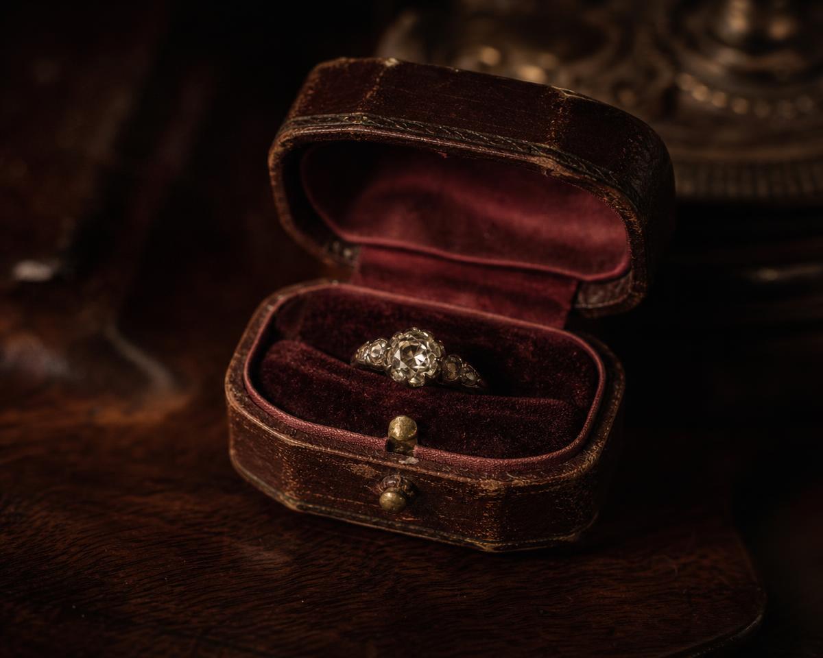 A small ring box passed across a wooden counter