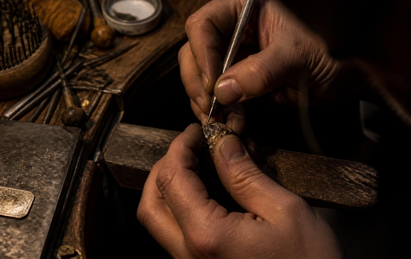 A goldsmith setting a stone at the bench